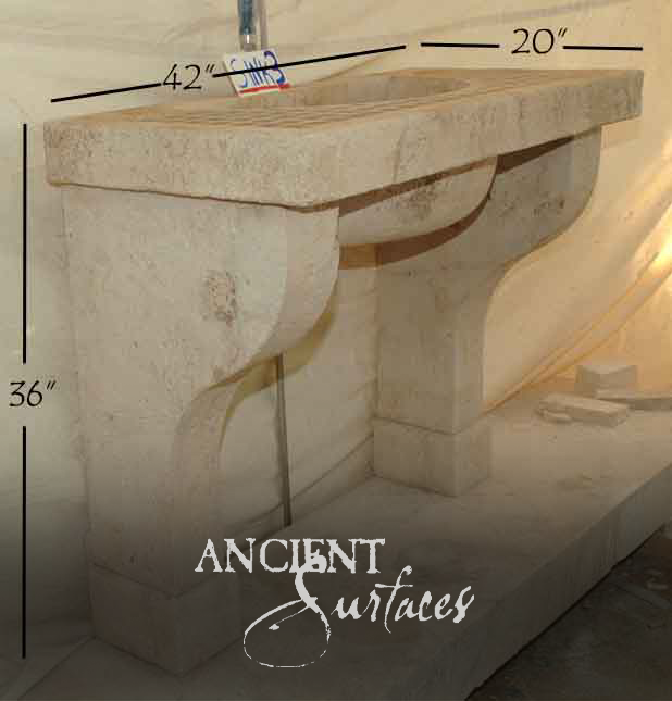 Cream limestone wall-mounted lavabo sink on a scrolling corbel bracket
