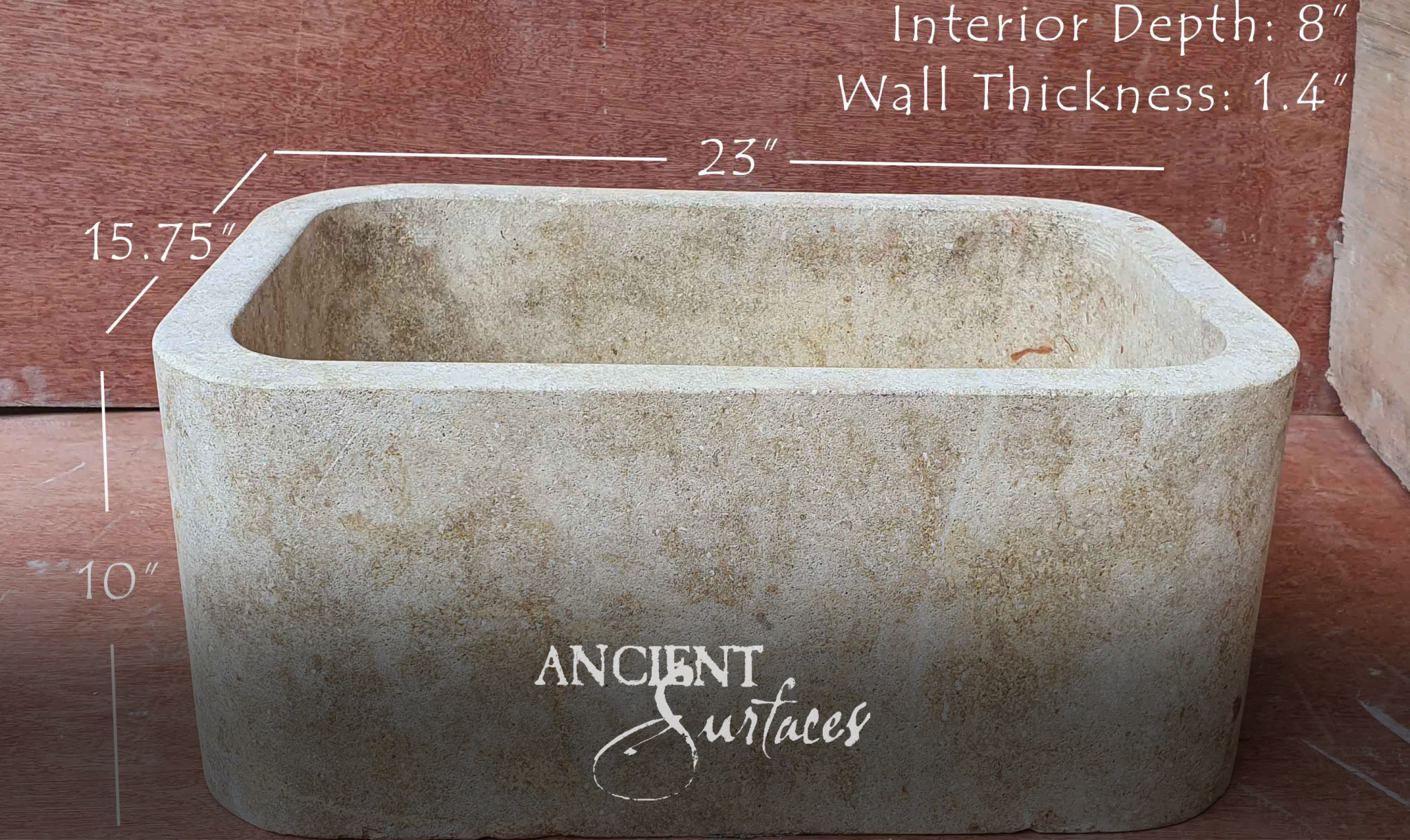 Compact rough-cut cream limestone trough basin with thick rounded walls
