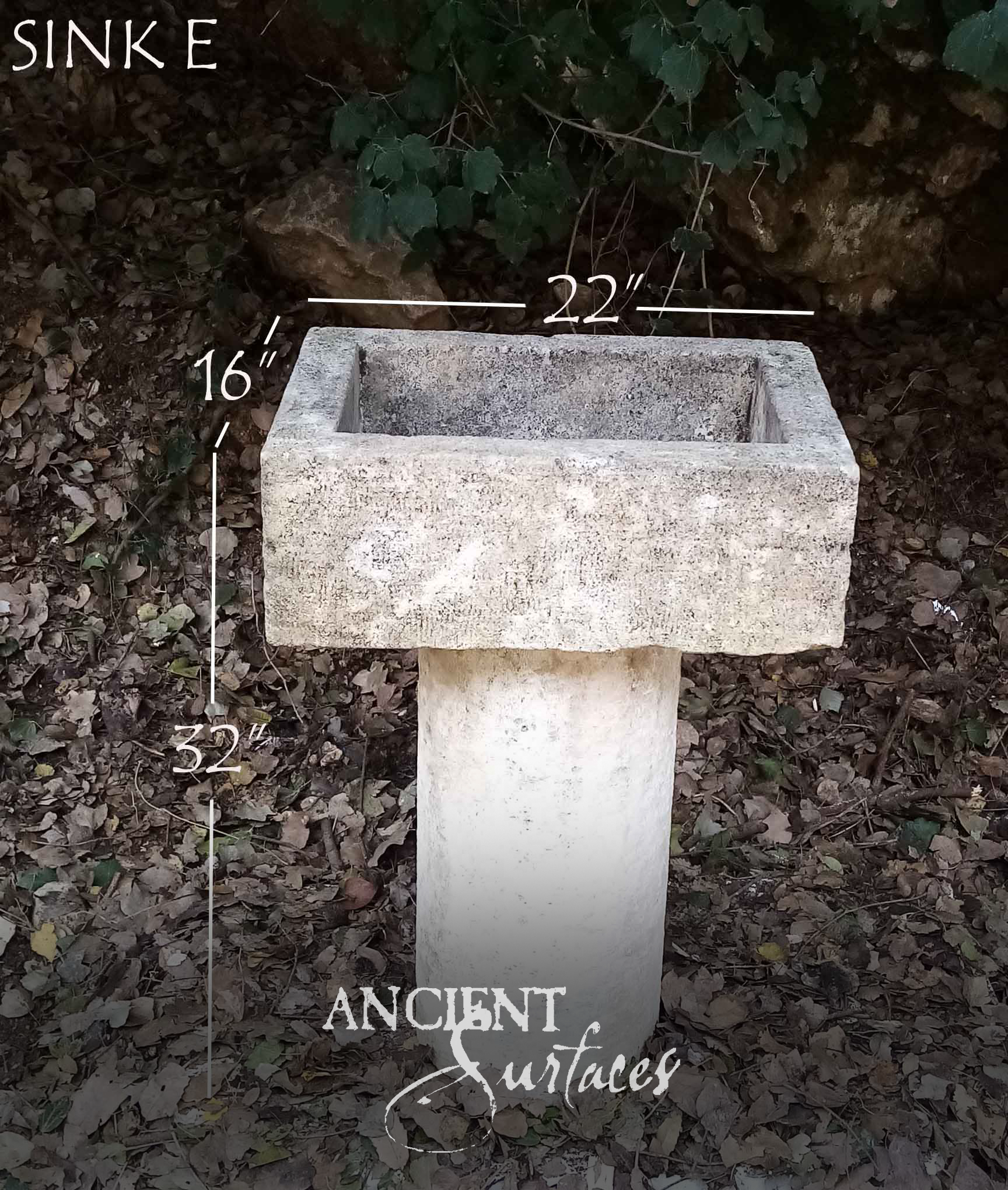 Square weathered stone garden basin on a tapering square pedestal