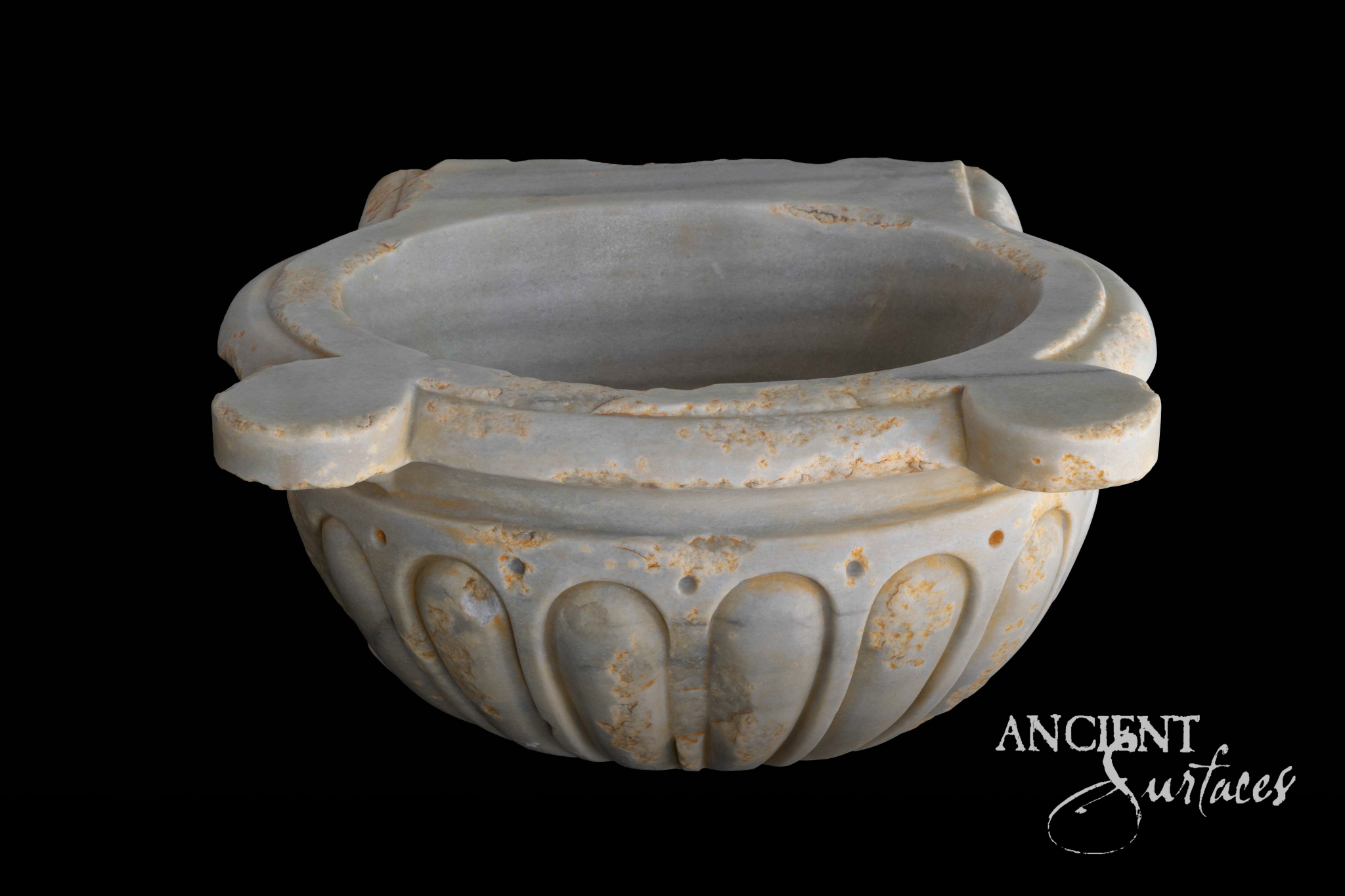 Round white marble bowl sink with scalloped quatrefoil rim and gadrooned body