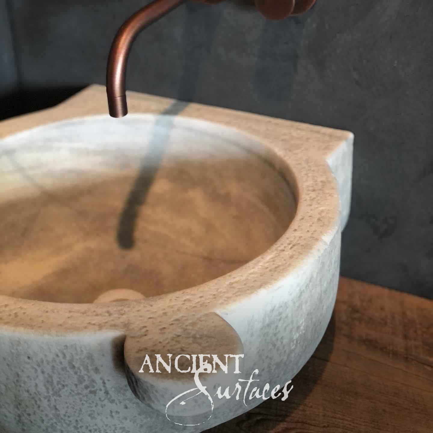 Antique travertine wall basin with copper faucet